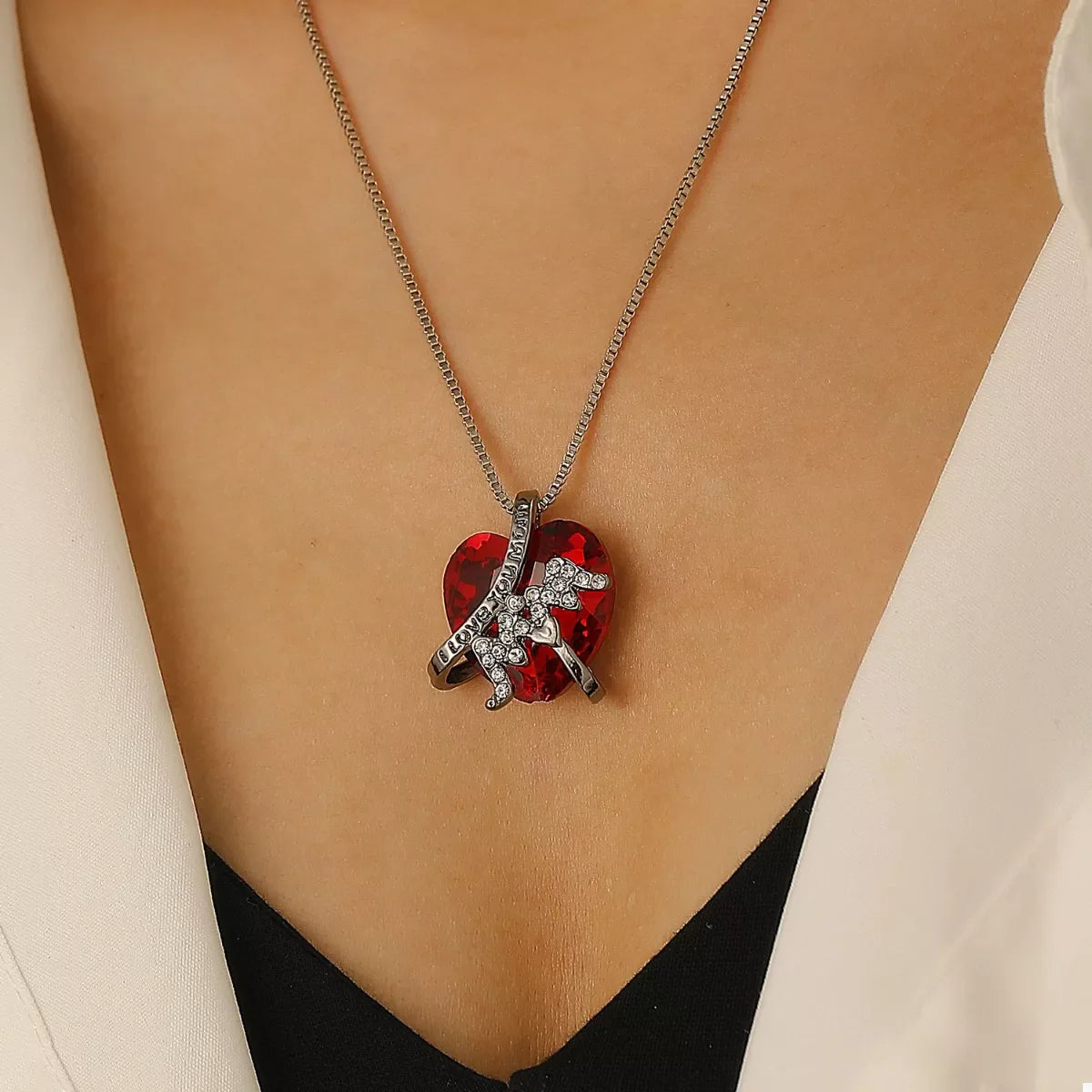 Heart-shaped MOM pendant necklace featuring a silver chain and a polished heart pendant, stylish jewelry for moms.