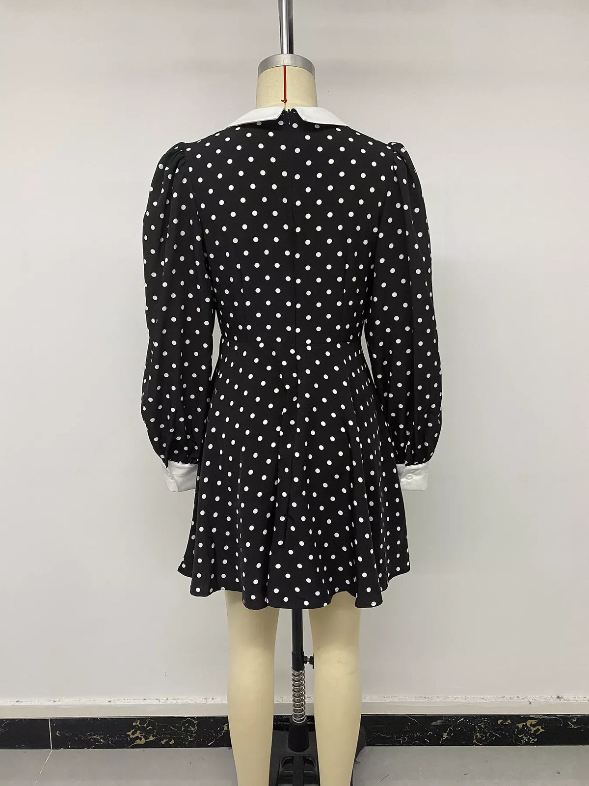 Polka dot Peter Pan collar dress by Plush Fashion Hub, featuring a classic design with a playful polka dot pattern and a rounded collar.