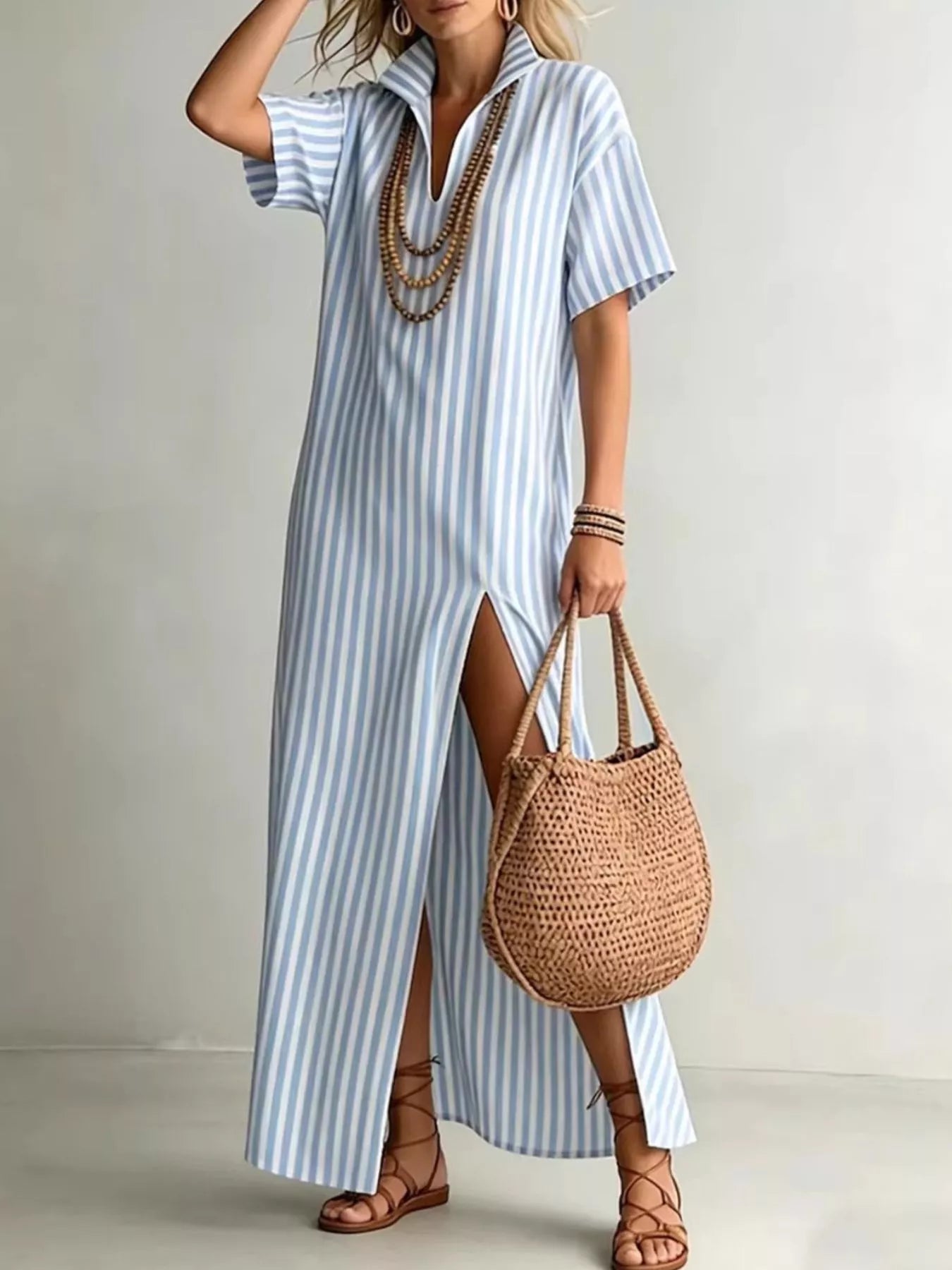 Striped high slit maxi shirt dress by Trendsi featuring a flowing design and bold vertical stripes for a stylish look.