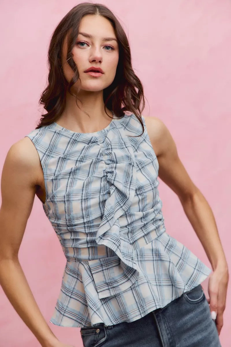 Plaid sleeveless ruffle peplum top by Plush Fashion Hub, featuring a stylish plaid pattern and feminine ruffle details.
