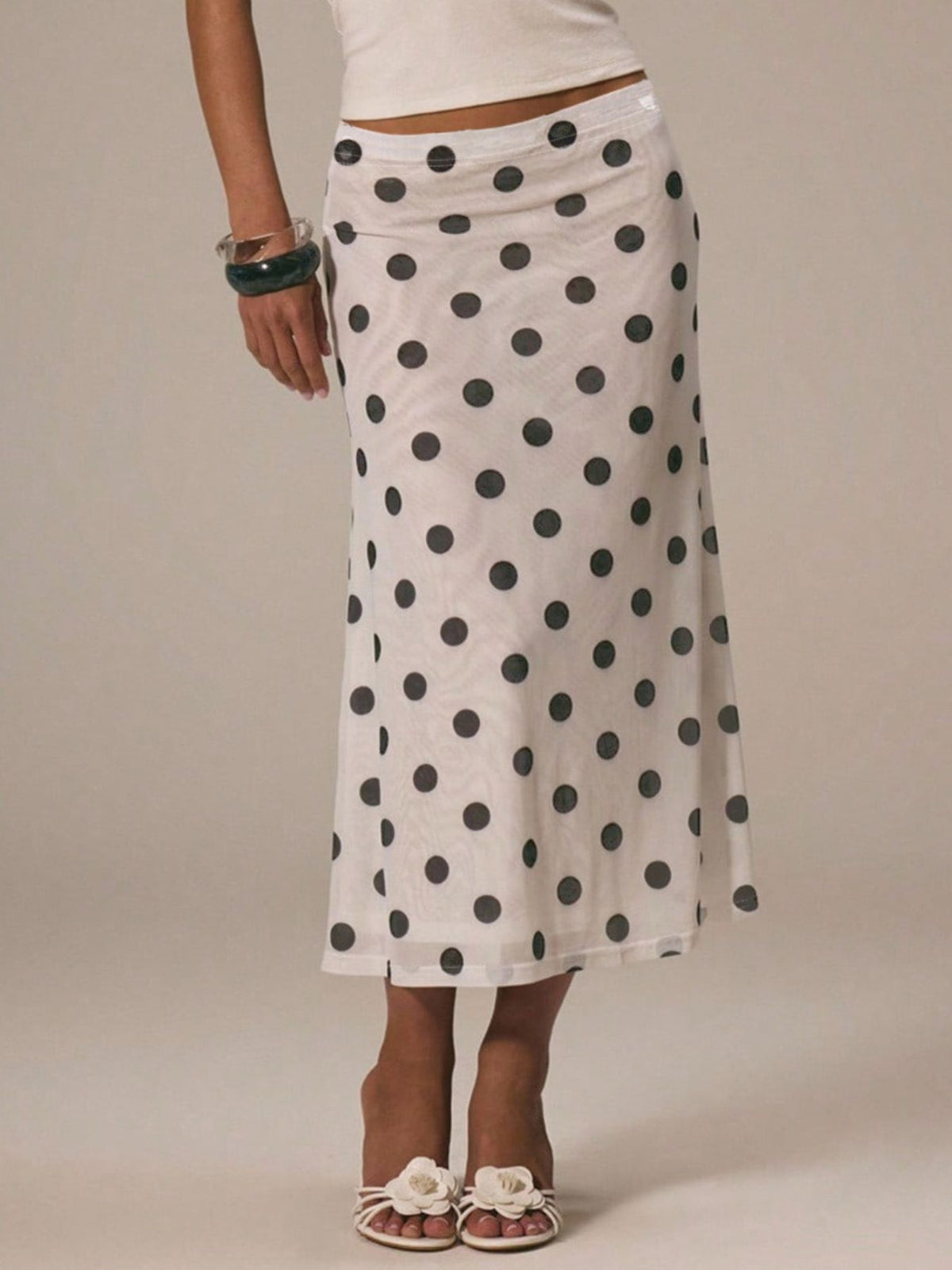 Women's vintage-inspired polka dot midi skirt from Plush Fashion Hub, high-waisted A-line design with classic style and feminine fit.