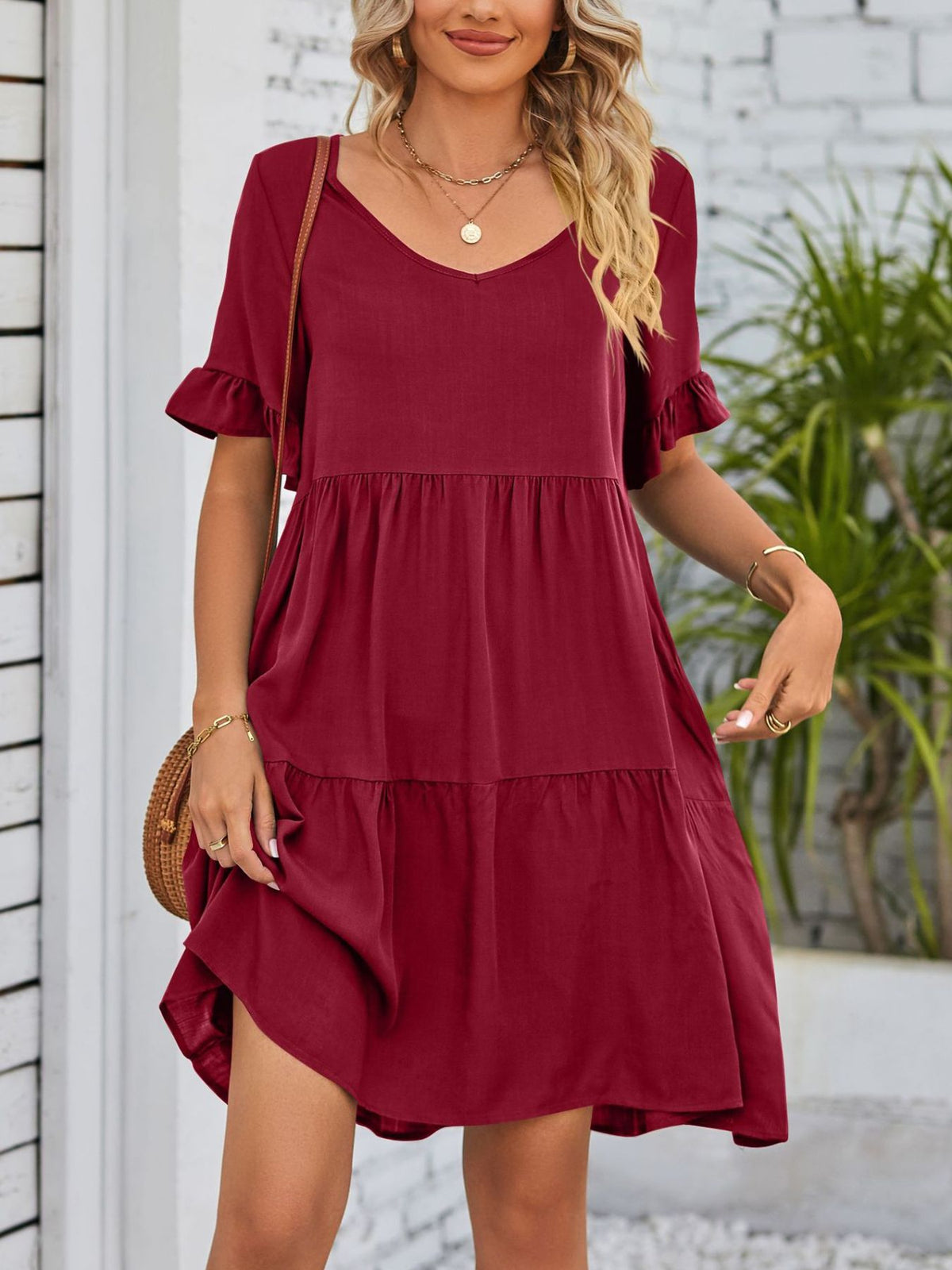 Lightweight rayon mini dress with ruffled sleeves, tiered design, and pockets from Plush Fashion Hub, perfect for casual summer wear.