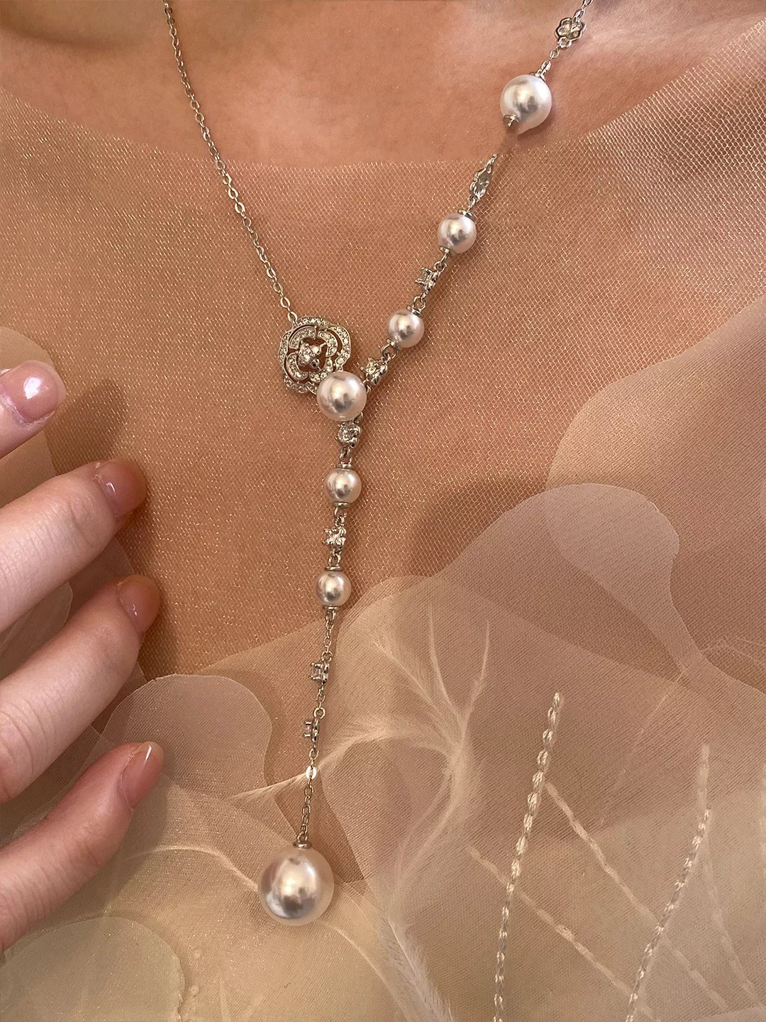 Pearl flower Y-necklace from Plush Fashion Hub featuring elegant white pearls and a floral pendant on a delicate chain