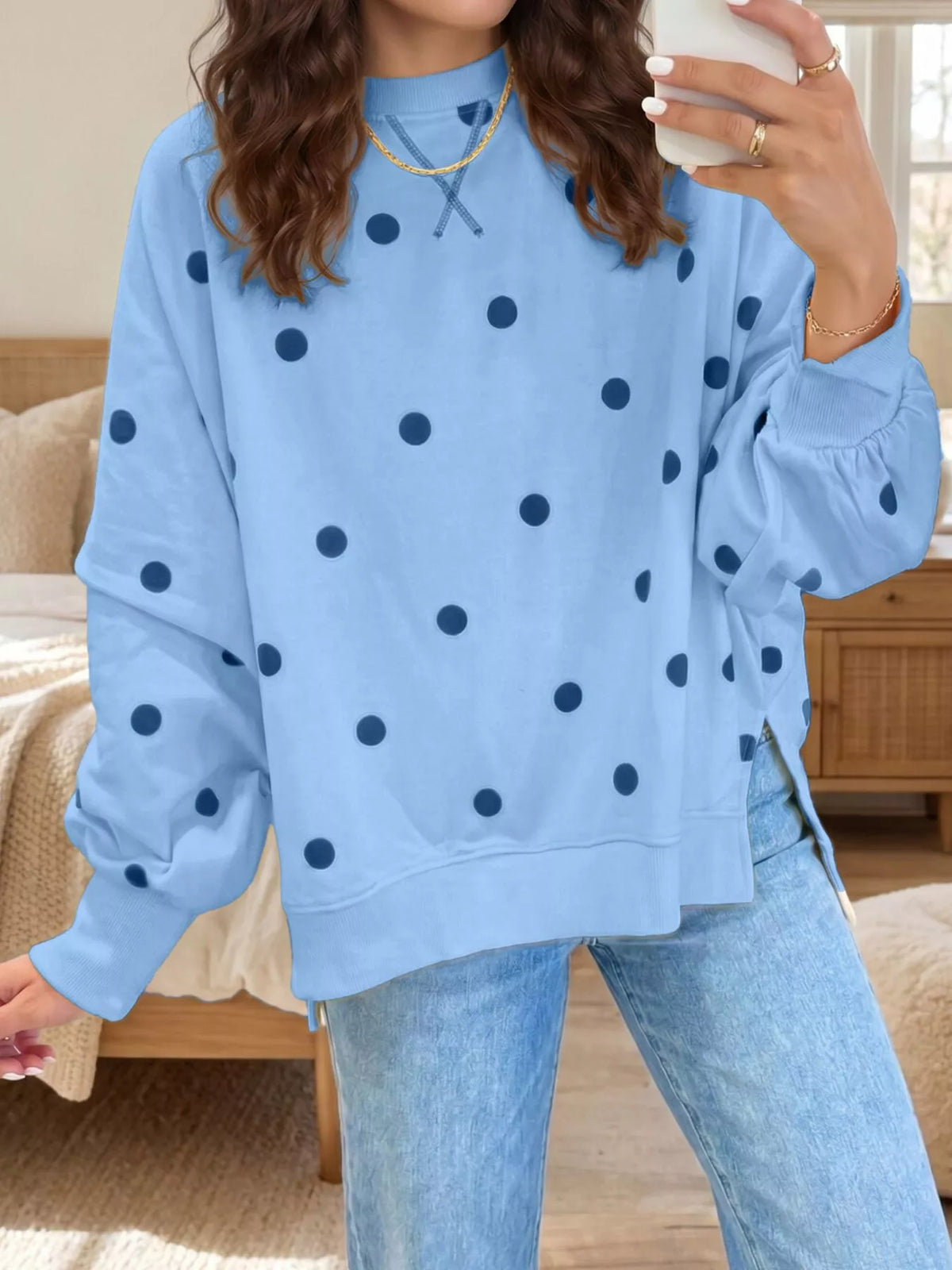 Oversized polka dot sweatshirt with side slit from Trendsi, featuring a comfortable fit and stylish design.