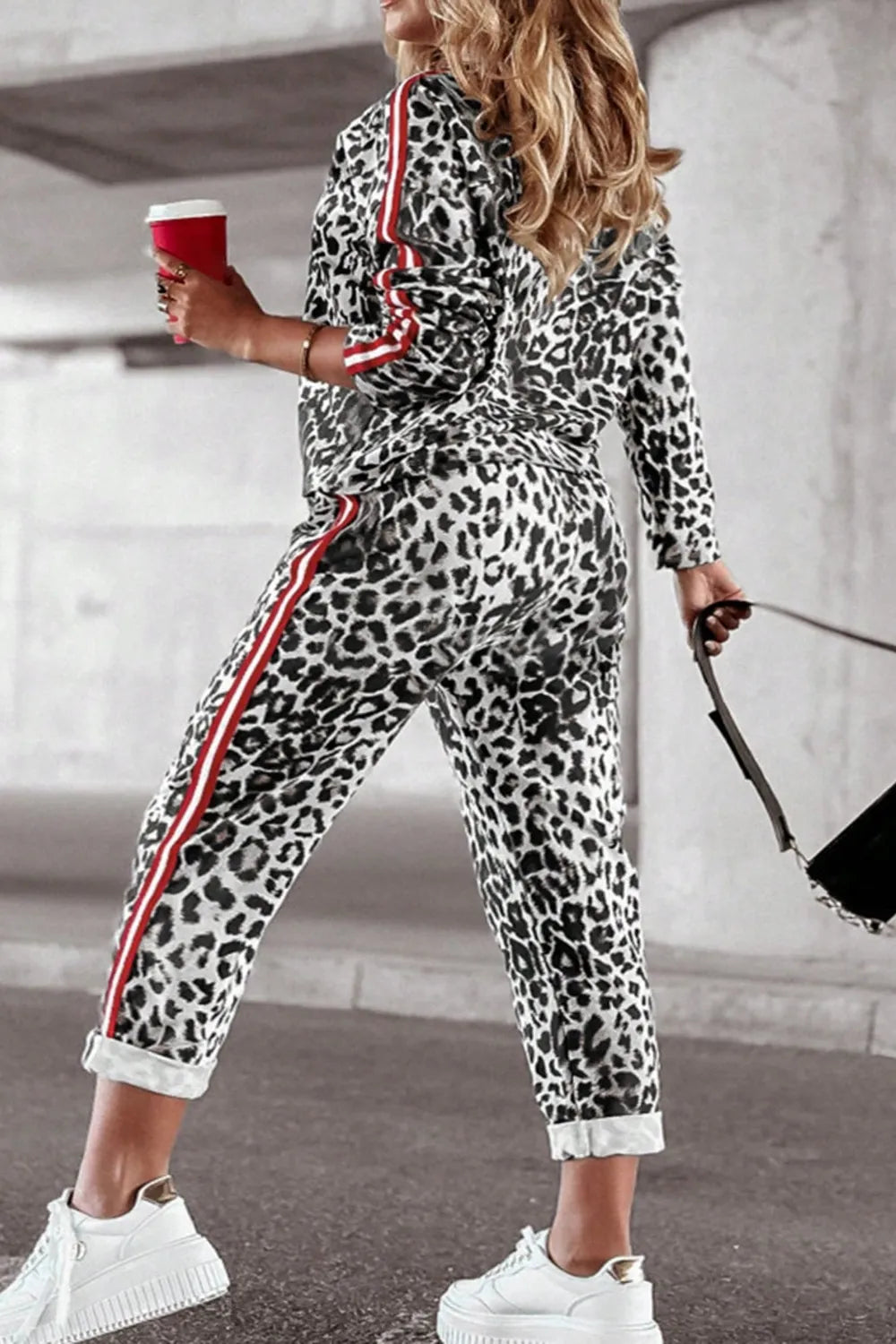 Plus size leopard print round neck top and pants set from Trendsi, casual and stylish ensemble for a bold look.
