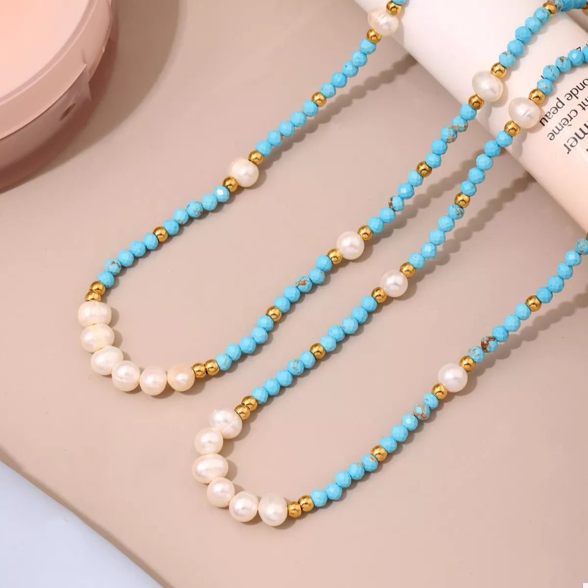Turquoise pearl beaded necklace by Plush Fashion Hub featuring round beads on a delicate string.
