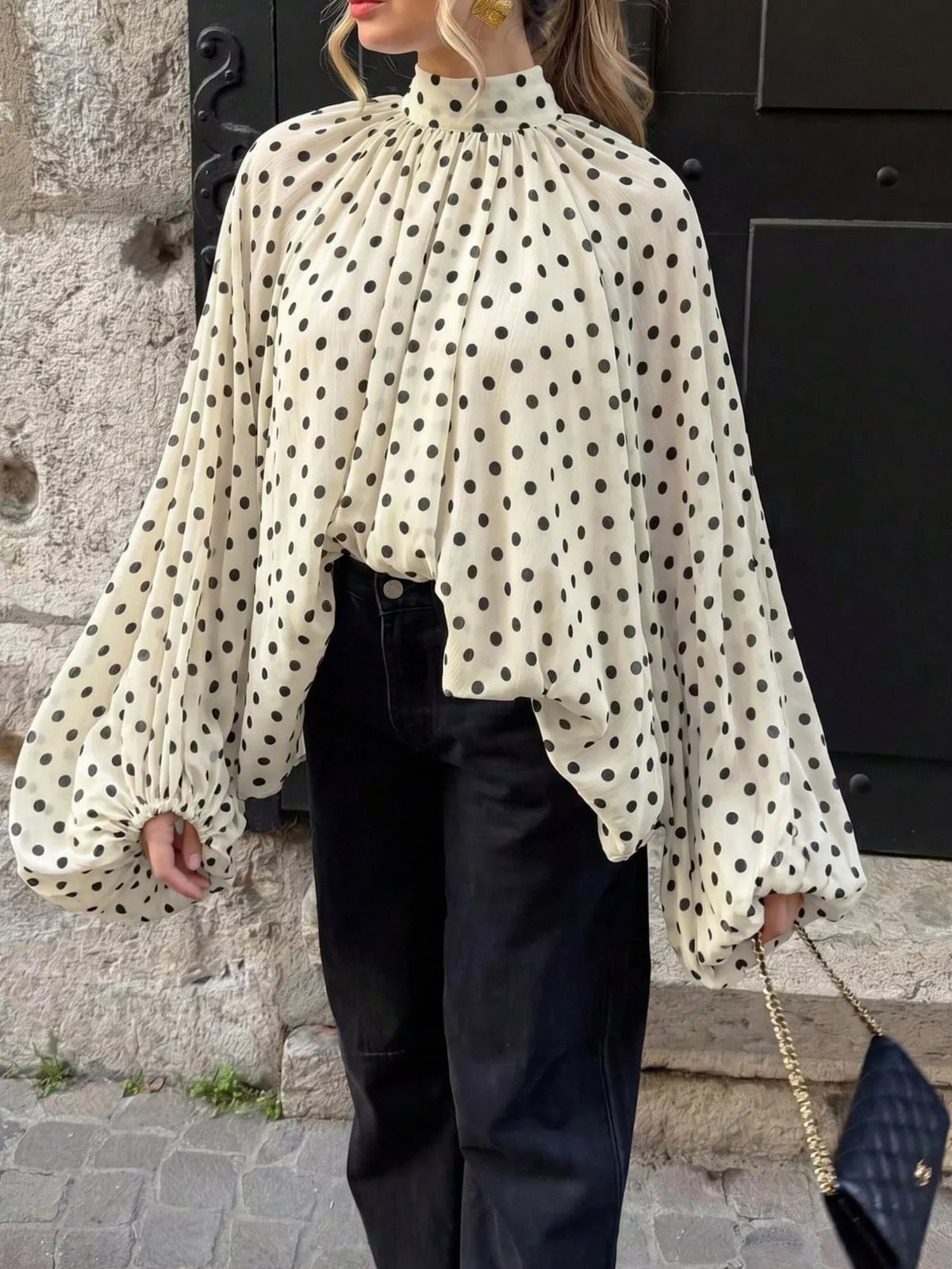 Polka dot balloon sleeve blouse for women by Trendsi, showcasing a stylish blouse with puffed sleeves and a playful polka dot pattern.