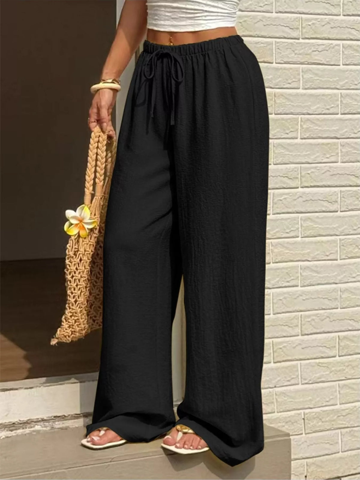 Plus size high-waisted wide-leg pants from Plush Fashion Hub displayed on a model, showcasing the flowy fabric and comfortable fit.