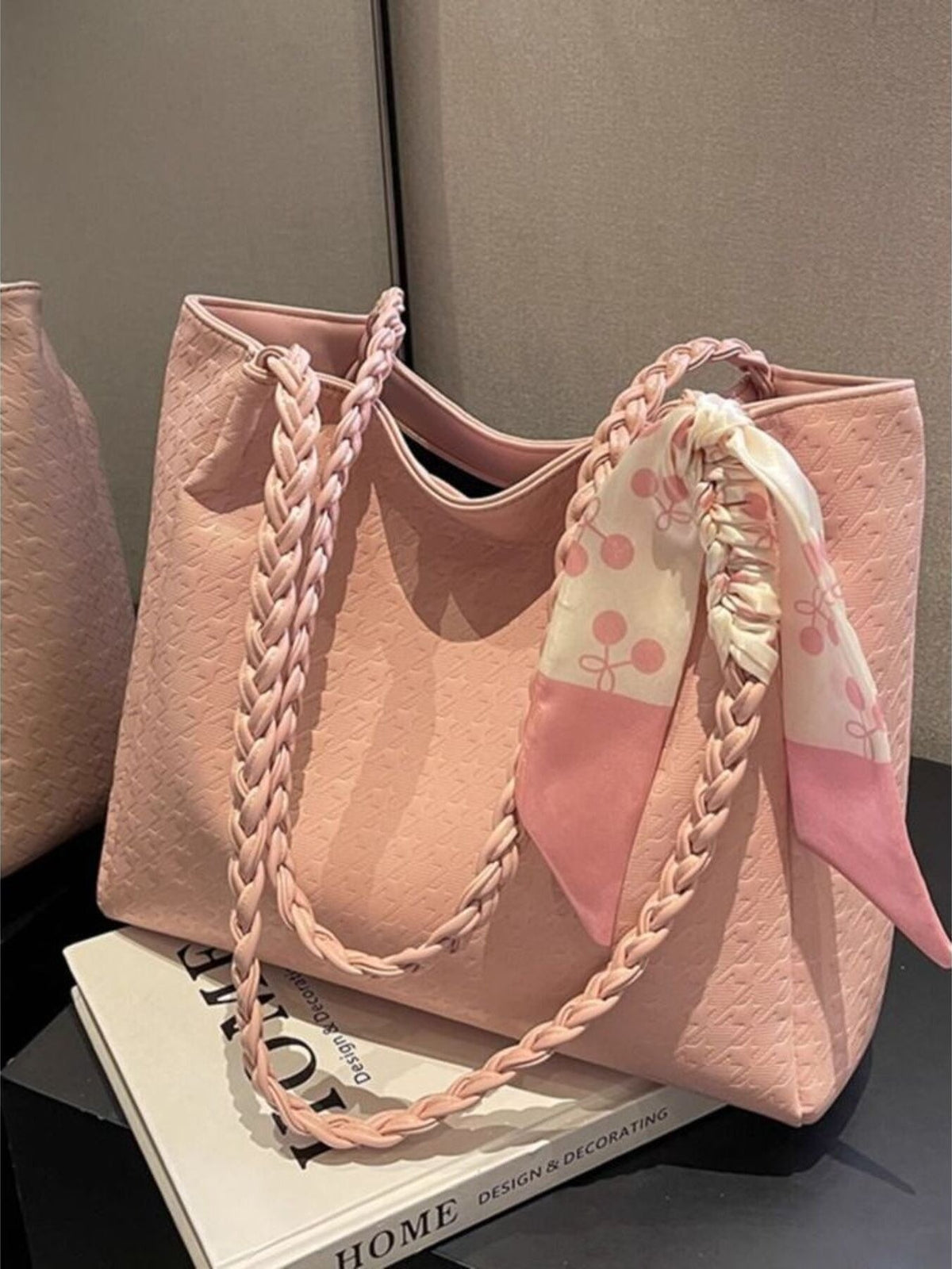 Plush Fashion Hub braided handle tote bag with woven design, stylish and spacious for everyday use, shown with handles and texture detail.