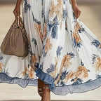 Women's floral print maxi dress with deep V-neck and flare sleeves, casualwear by Plush Fashion Hub, shown on a model.