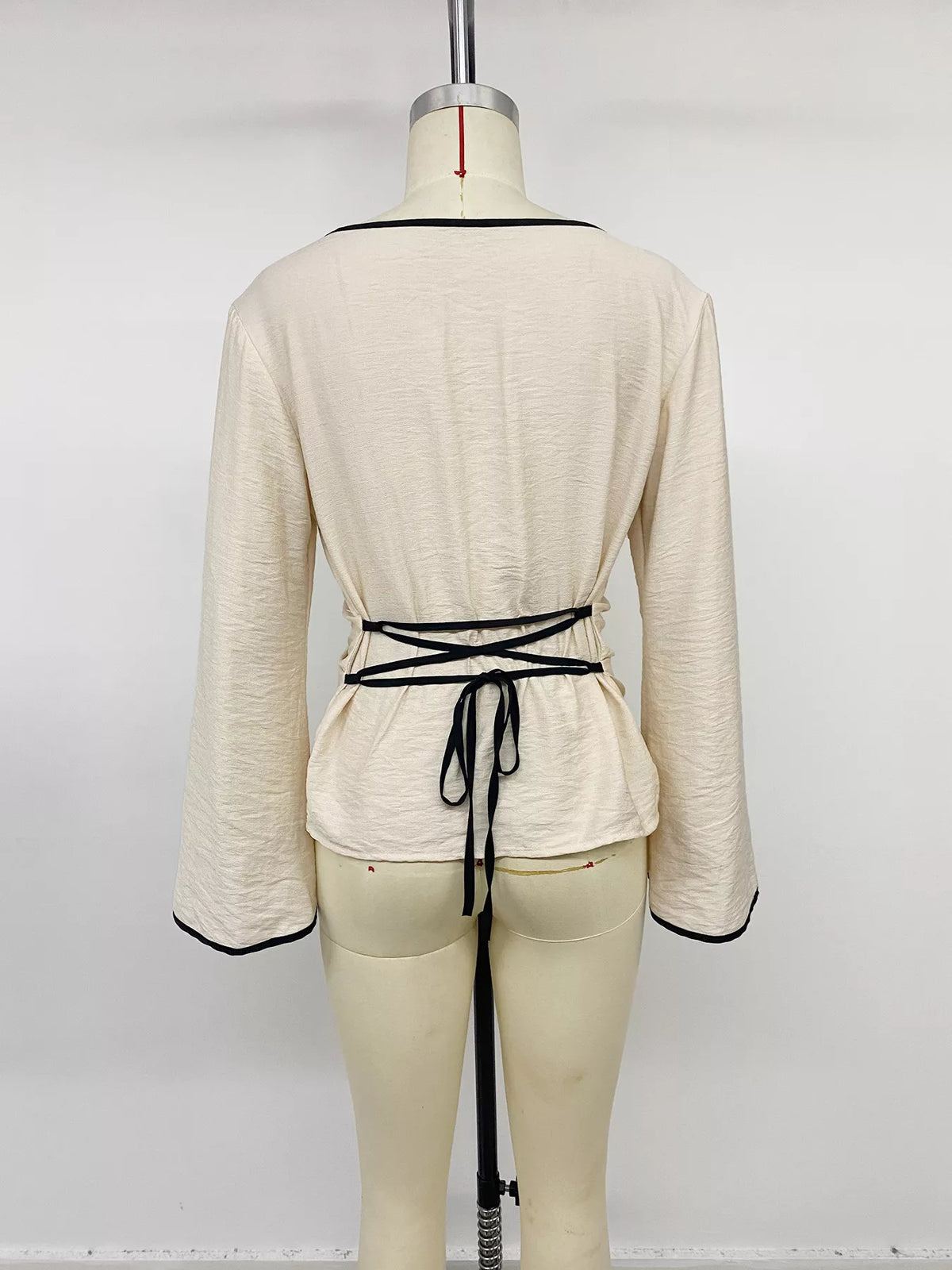 Plush Fashion Hub contrast trim flare sleeve blouse with stylish design, featuring flare sleeves and a fitted silhouette.