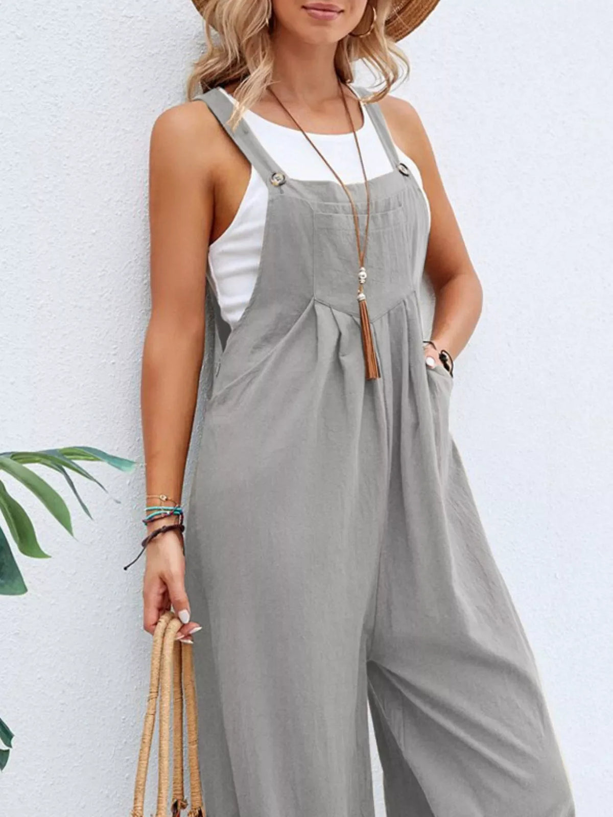 Plus size casual wide-leg jumpsuit with pockets from Plush Fashion Hub, featuring a full-size relaxed fit and stylish design.