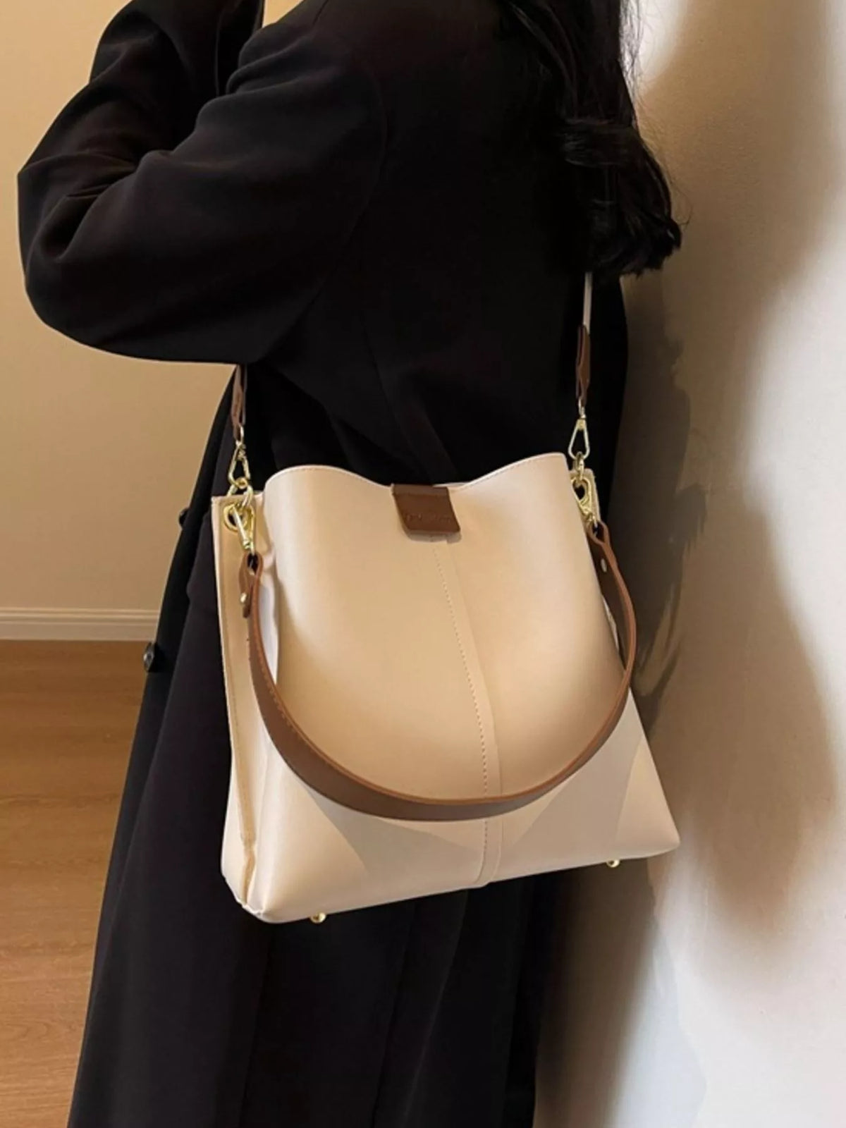 Plush Fashion Hub PU leather crossbody handbag with adjustable strap and gold-tone hardware, stylish and compact for everyday use.