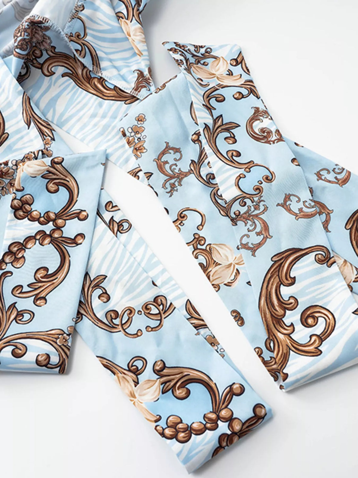 Printed long sleeve romper with a cutout front, stylish jumpsuit by Plush Fashion Hub, shown in the product image.