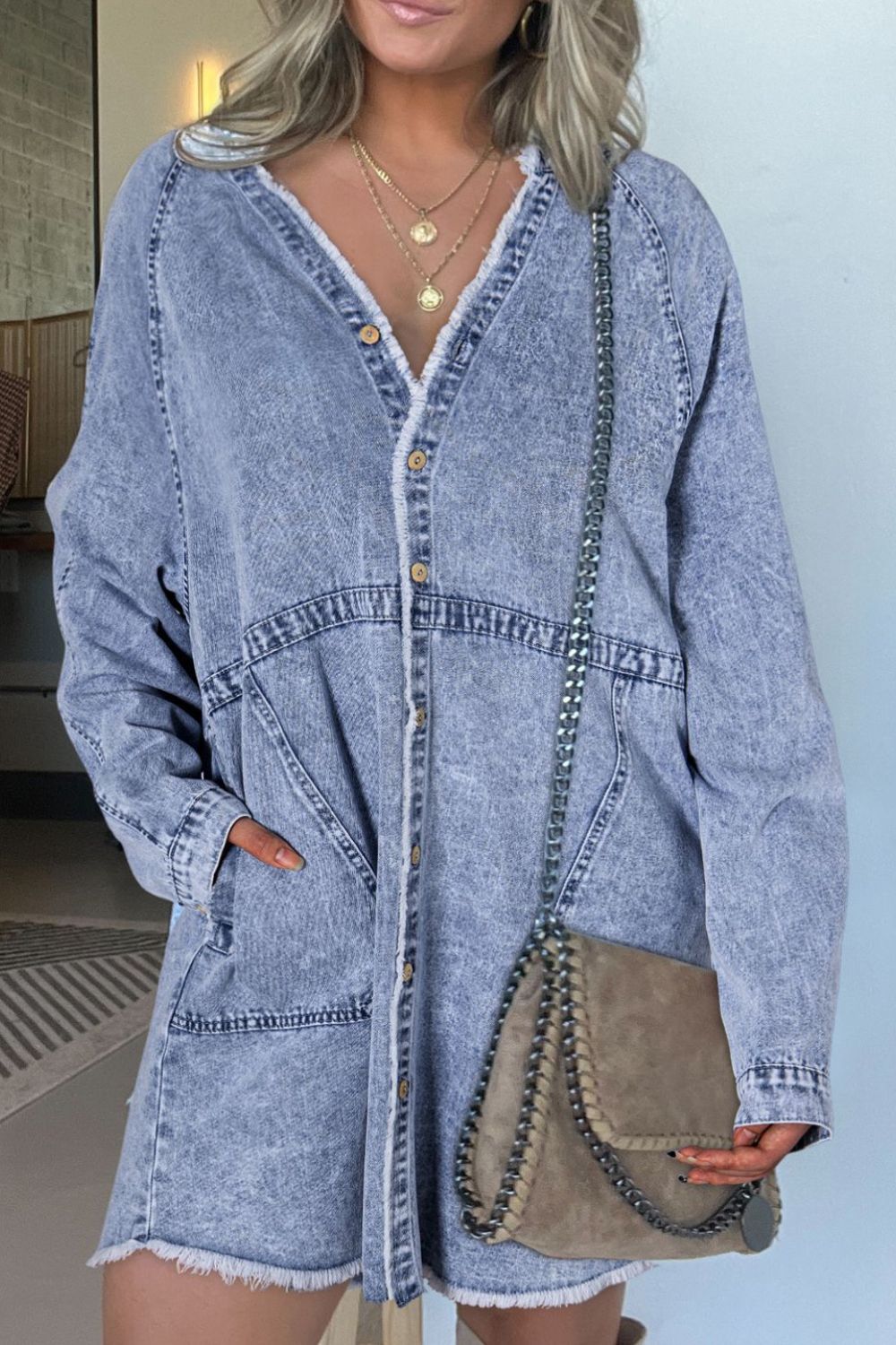 Raw hem button-down long sleeve denim dress by Plush Fashion Hub, featuring a casual fit and classic blue denim fabric.