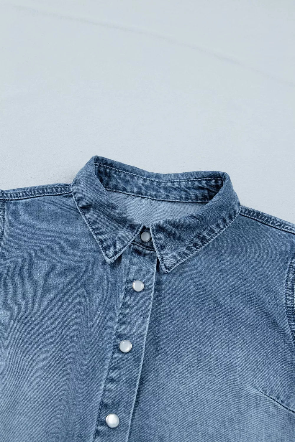 Plush Fashion Hub frilled short sleeve denim shirt with snap buttons, featuring a stylish and casual design.