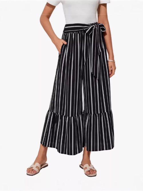 Plus size printed wide-leg pants with a tie waist from Trendsi, featuring a full length and stylish pattern.