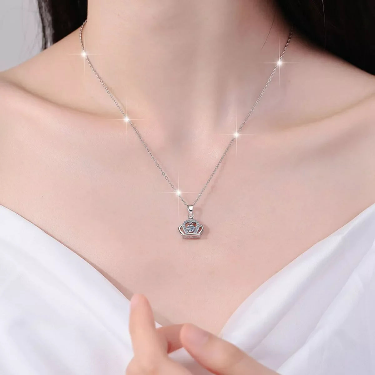 Sterling silver zircon crown pendant necklace with intricate detailing, featuring a sparkling crown design on a delicate chain.