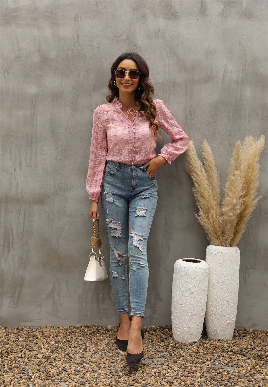 Bella Mia women's long sleeve V neck shirt with floral embroidery and wooden earrings detail, showcasing a stylish top.