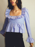 Summer Wind Bella Mia long sleeve ruffled shirt in solid color, featuring a stylish, feminine design perfect for warm weather.