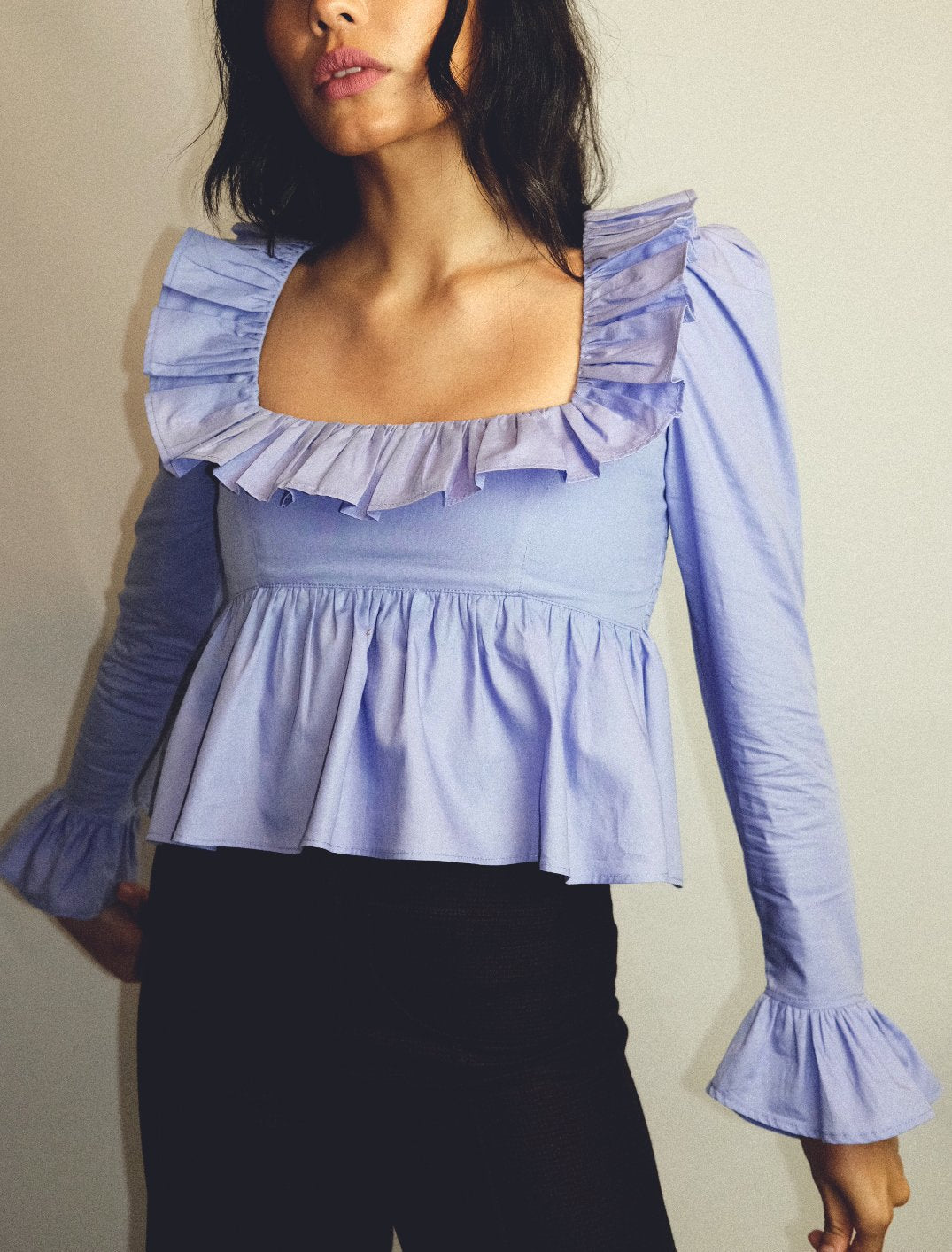 Summer Wind Bella Mia long sleeve ruffled shirt in solid color, featuring a stylish, feminine design perfect for warm weather.