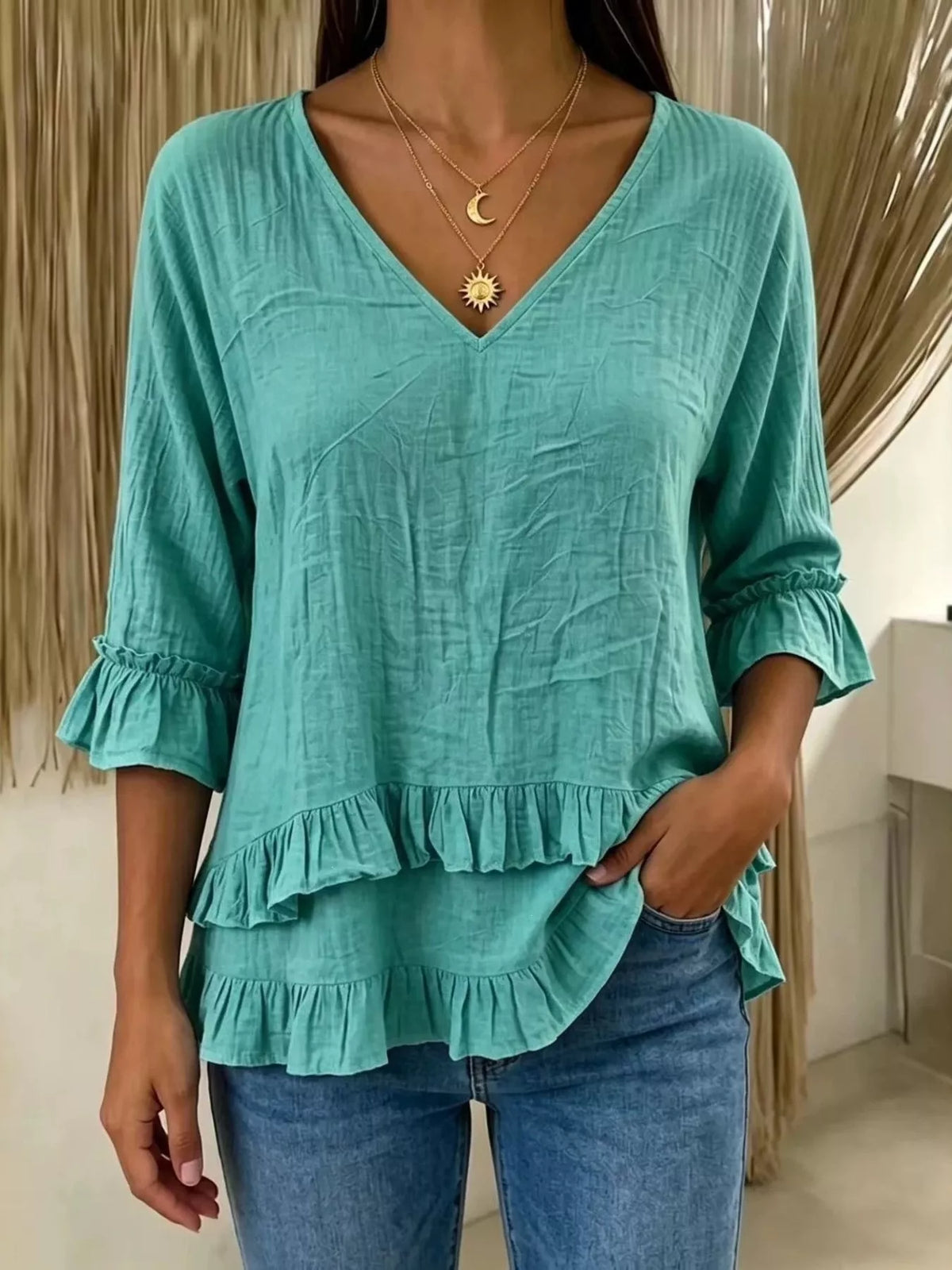 V-neck ruffle sleeve blouse by Trendsi featuring a stylish cut, soft fabric, and feminine ruffle details in a flattering design.