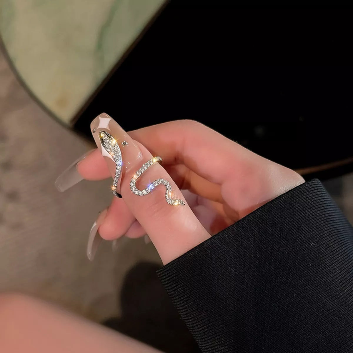 Sterling silver zircon snake bypass ring with sleek design, featuring sparkling zircon stones and smooth silver finish.