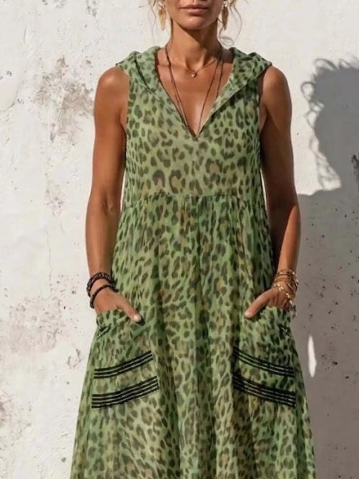 Plus size leopard print sleeveless hooded maxi dress with pockets from Trendsi, featuring a full-length design and bold animal print.