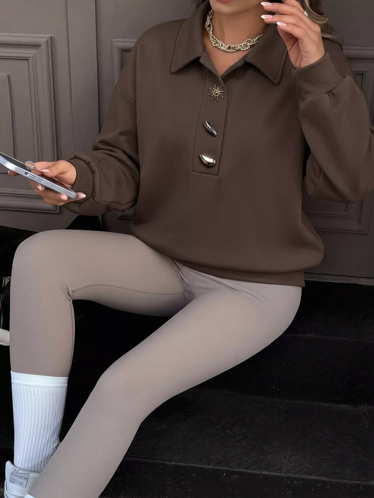 Trendsi polo collar dropped shoulder sweatshirt showing soft fabric, relaxed fit, and stylish design on a neutral background.