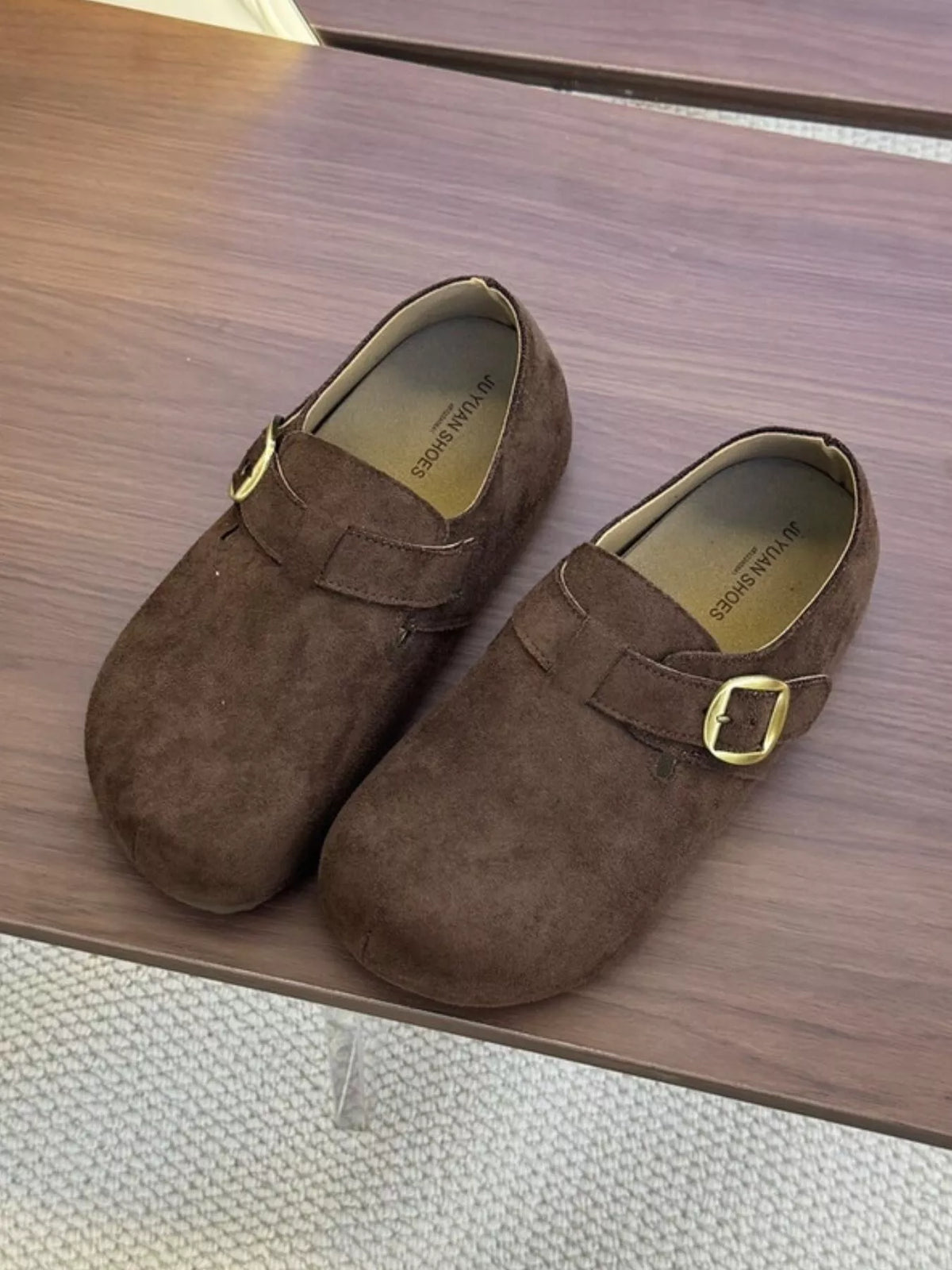 Women's suede buckle slip-on shoes from Trendsi, featuring a stylish design with a buckle detail and comfortable slip-on style.