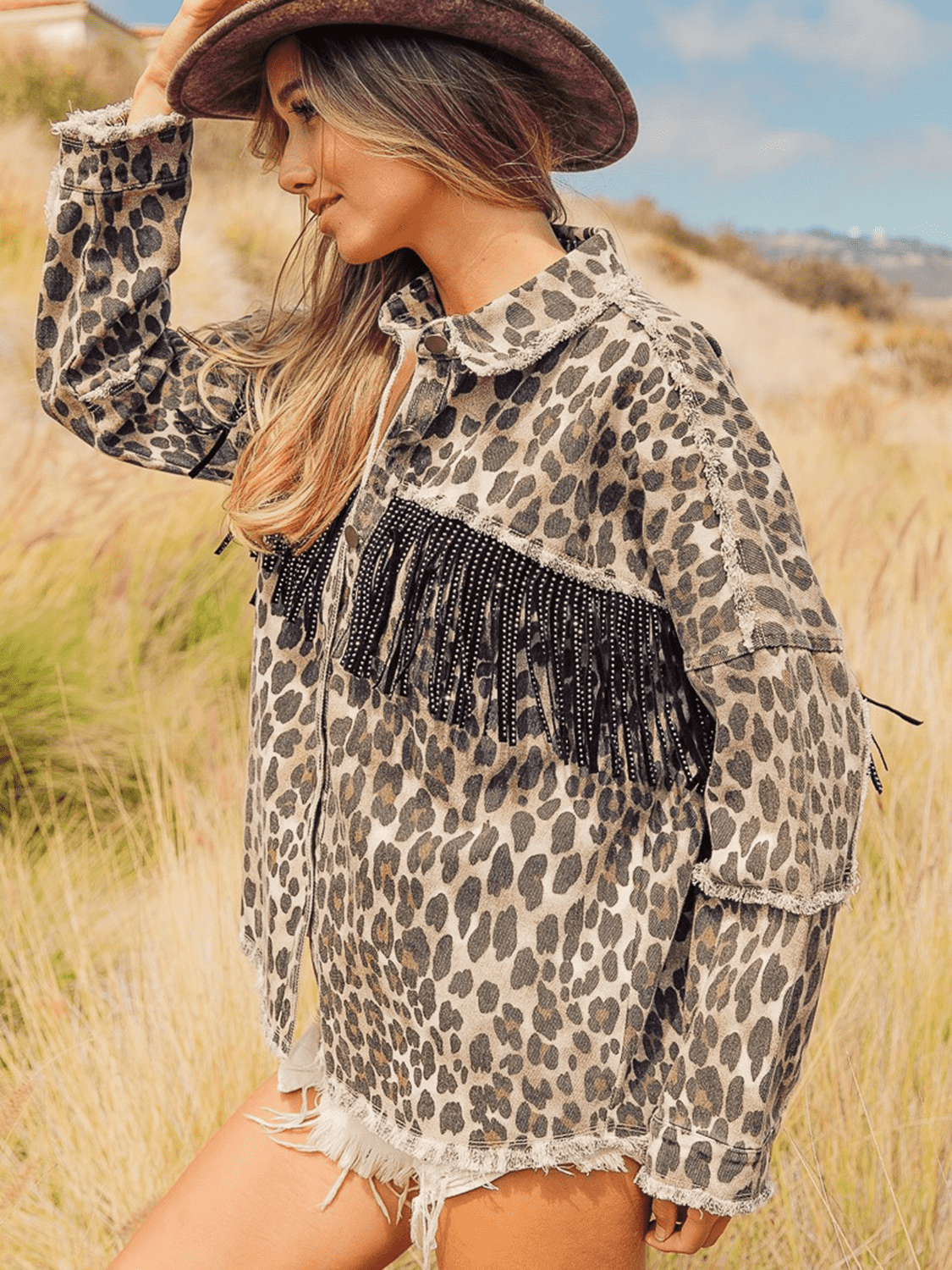 Leopard fringe detail collared denim jacket by Plush Fashion Hub, featuring leopard print, fringes, and classic denim design.
