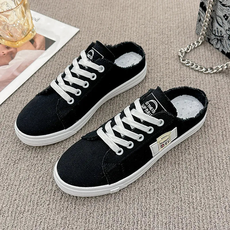Frayed hem lace-up canvas sneakers in white with a casual, distressed style and trendy design.