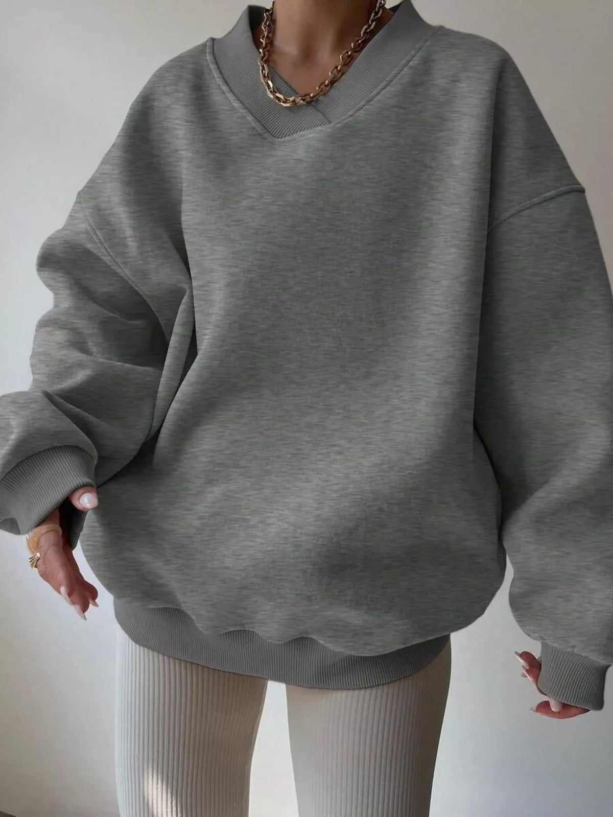 Oversized dropped shoulder long sleeve sweatshirt from Trendsi, featuring a relaxed fit and casual style.