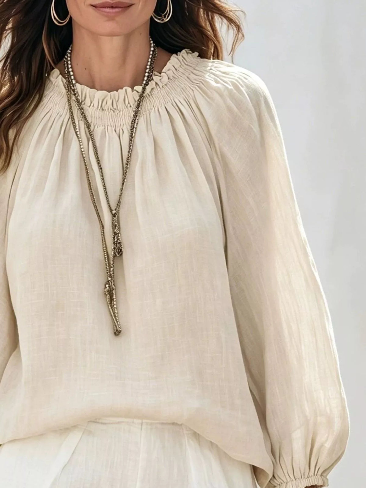 Women’s round neck balloon sleeve blouse by Trendsi, featuring a stylish fit and soft fabric, shown in a natural pose.