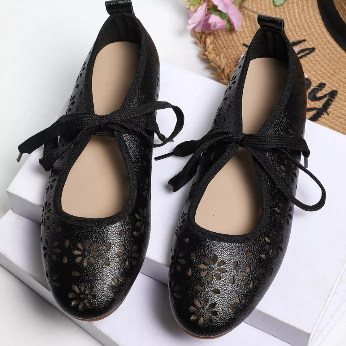 Floral cutout tied slip-on sandals by Plush Fashion Hub featuring open toes, floral accents, and comfortable slip-on design.