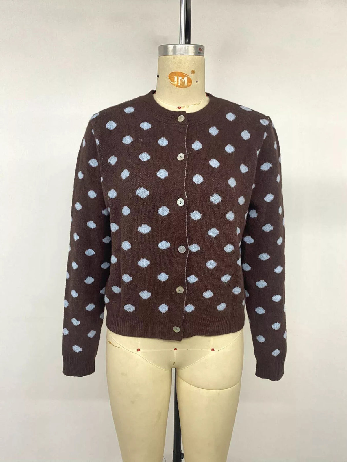 Women’s polka dot button-up cardigan by Trendsi, featuring a stylish knit design with a classic button front and long sleeves.
