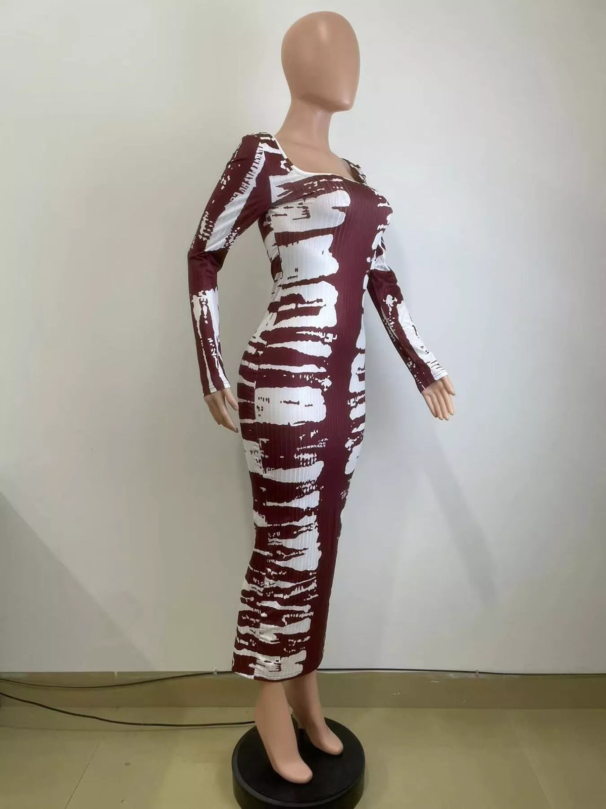 Colorful tie-dye long sleeve maxi dress by Plush Fashion Hub featuring a flowing silhouette and vibrant pattern.
