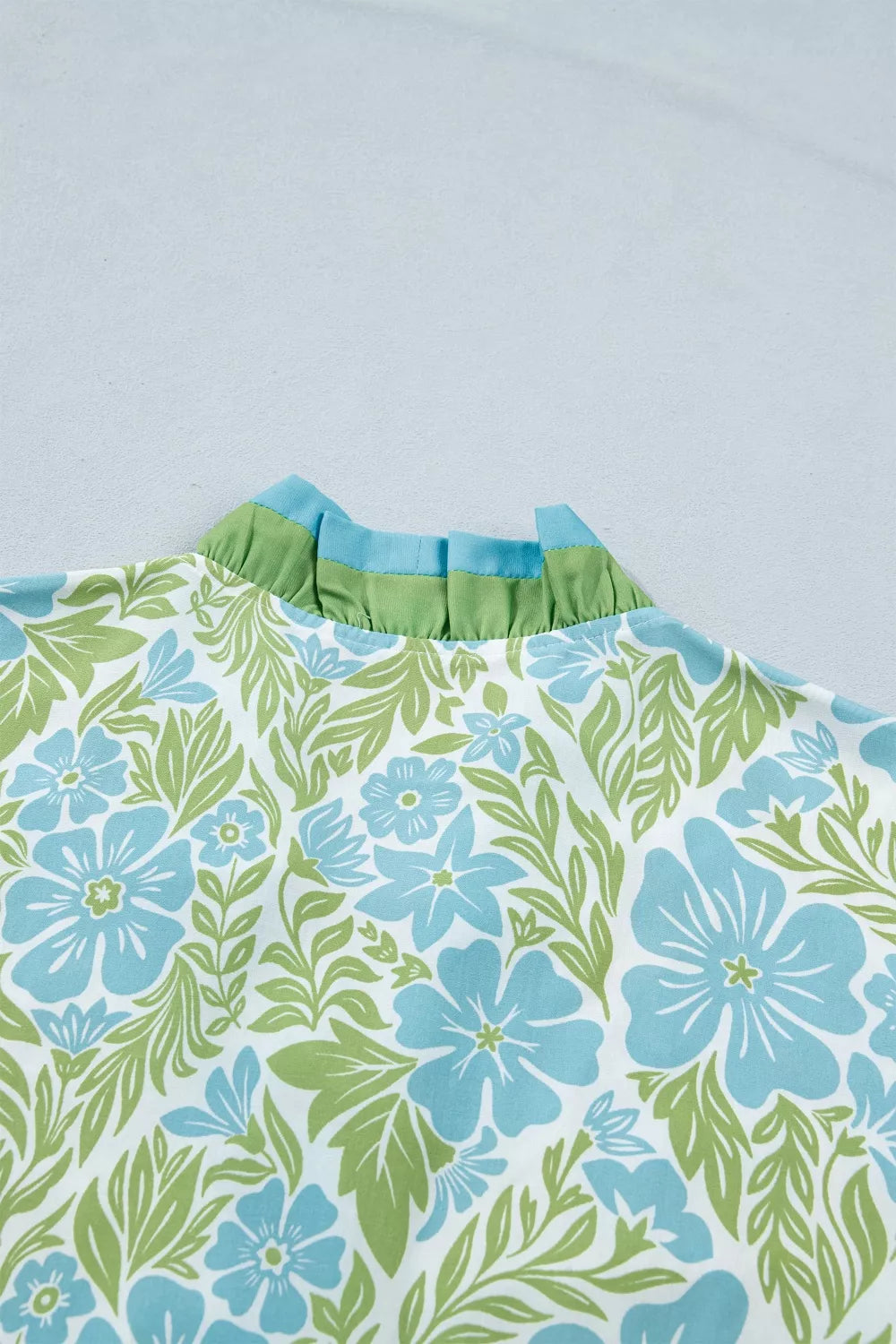 Floral print ruffle hem button-up mini dress from Trendsi showcasing a flattering fit and vibrant floral pattern.