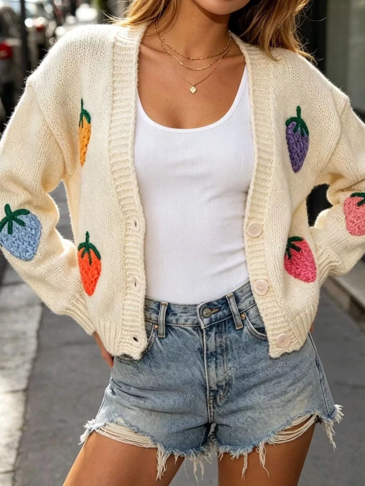 Plus size knit cardigan with colorful fruit appliqué details, trendy full-size knitwear by Trendsi.