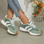 Women's round toe lace-up flat casual sneakers by Trendsi, featuring comfortable PU leather upper and classic design.