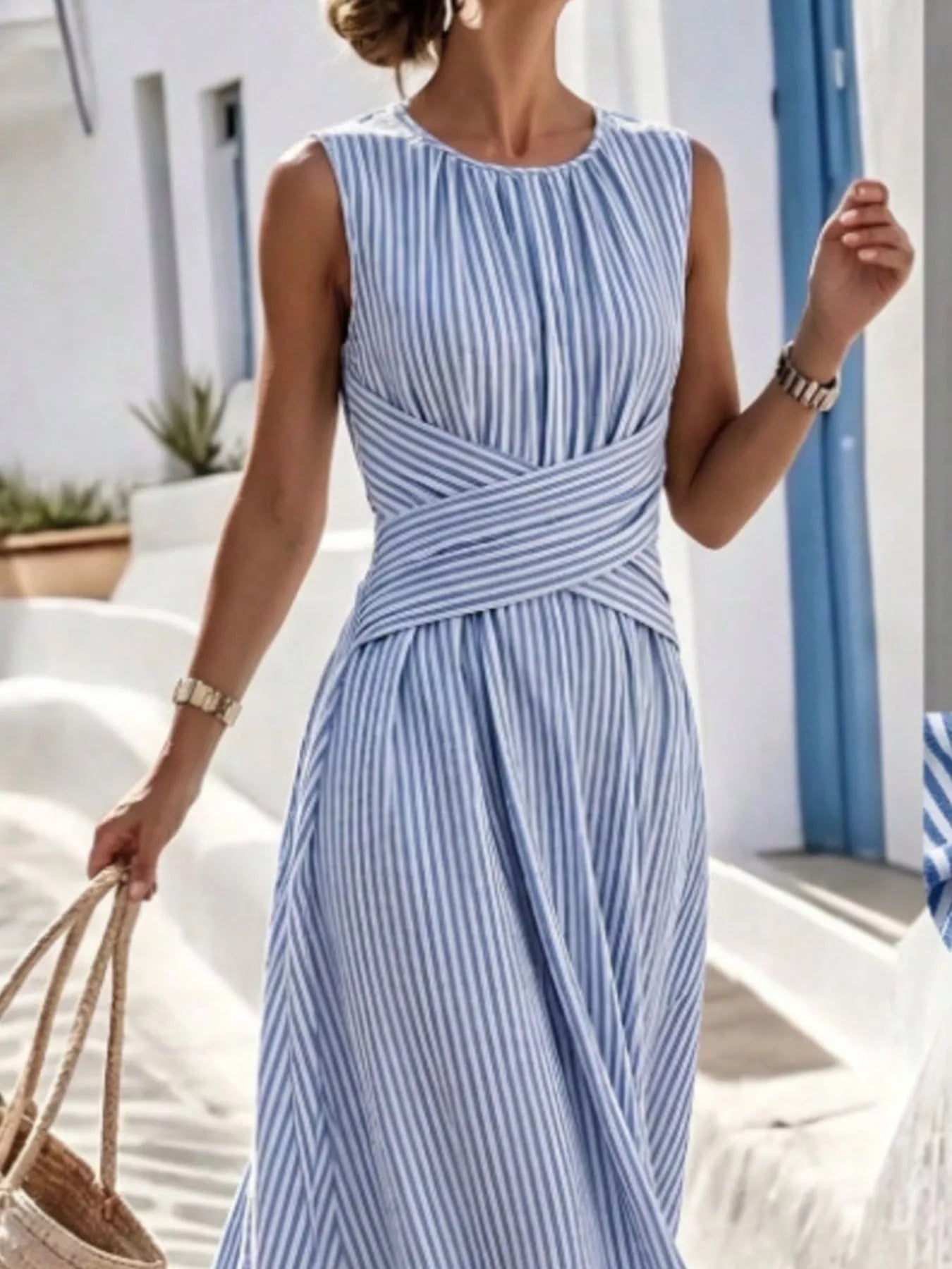 Plus size striped sleeveless maxi dress by Trendsi featuring a full-length design and bold vertical stripes.