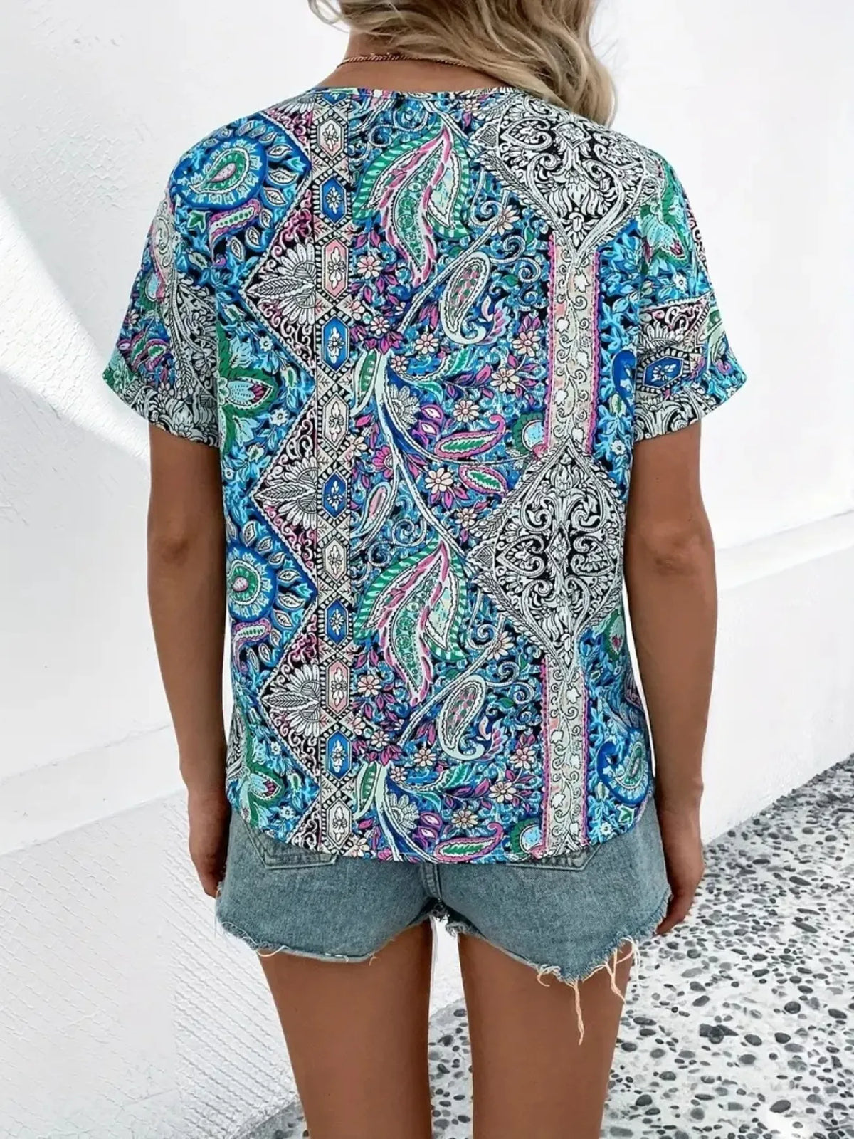Bohemian Paisley V-neck short sleeve T-shirt by Plush Fashion Hub featuring a colorful paisley pattern and relaxed fit.
