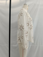 Embroidered floral mini shirt for women by Bella Mia, perfect for spring, featuring colorful floral details and a stylish fit.
