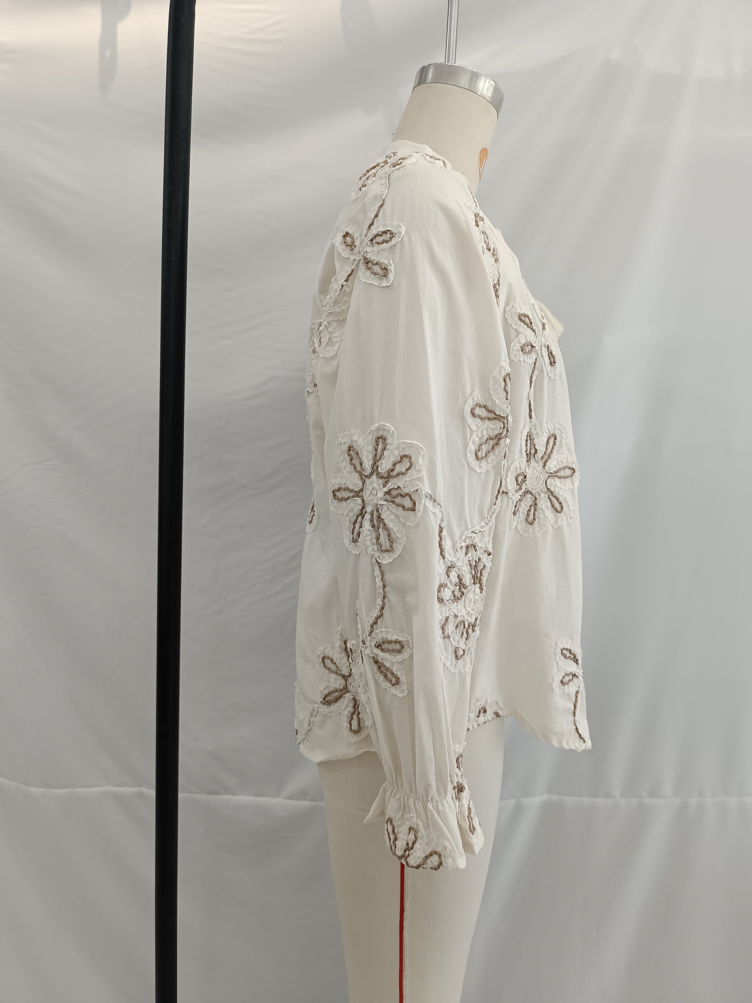 Embroidered floral mini shirt for women by Bella Mia, perfect for spring, featuring colorful floral details and a stylish fit.