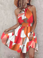 Paisley print halter neck mini dress by Plush Fashion Hub, featuring a stylish sleeveless design and vibrant pattern.