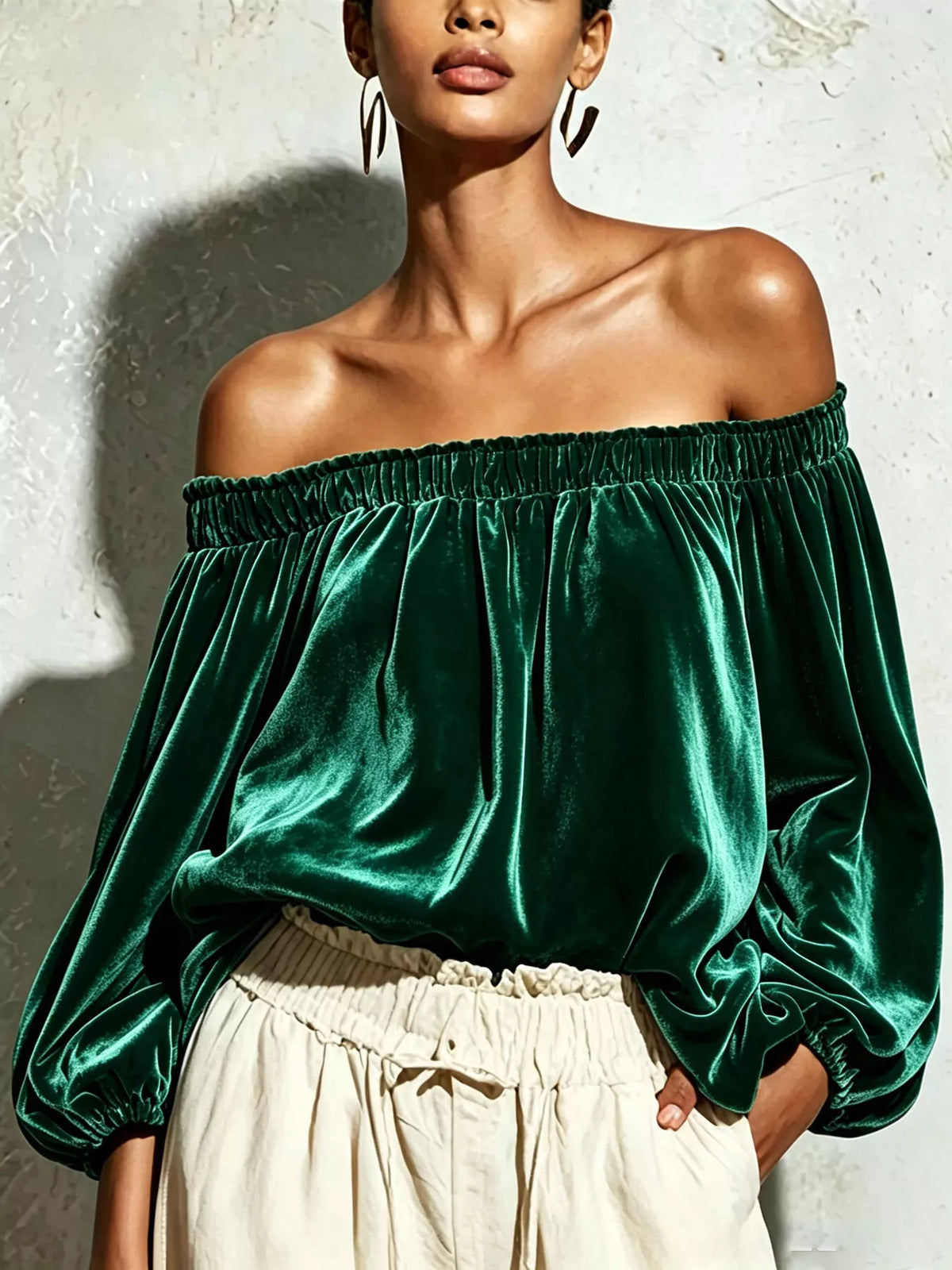 Velvet off-shoulder long sleeve T-shirt by Trendsi, featuring a fitted design and stylish off-shoulder neckline in black.