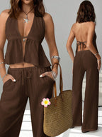 Women's chic halter neck cami and drawstring pants two-piece set by Trendsi, featuring stylish and comfortable design.