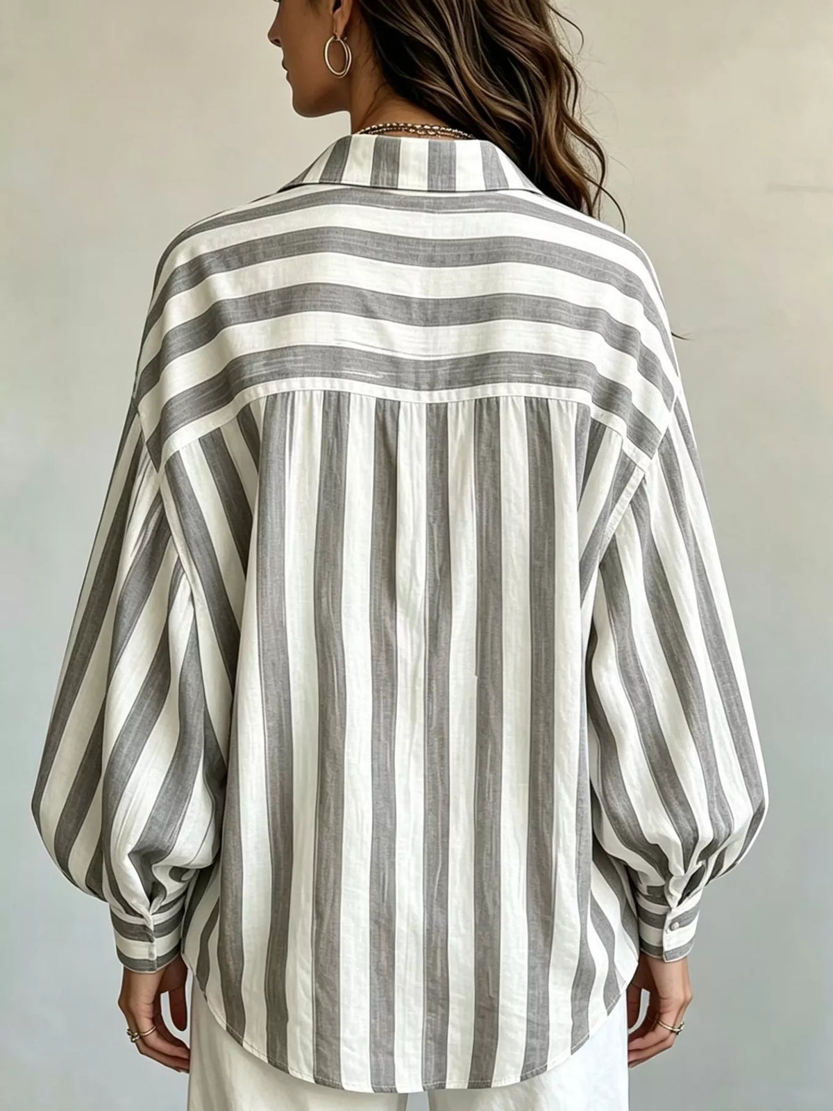 Women’s striped loose fit shirt by Trendsi, featuring a casual design with vertical stripes and relaxed fit, front view.