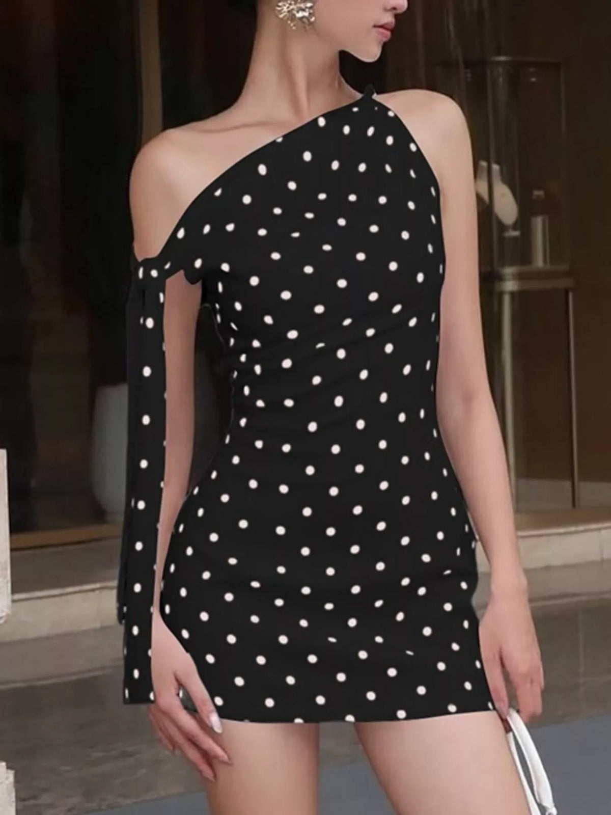 Polka dot sleeveless mini dress with bow accents from Plush Fashion Hub, featuring a playful and stylish design.