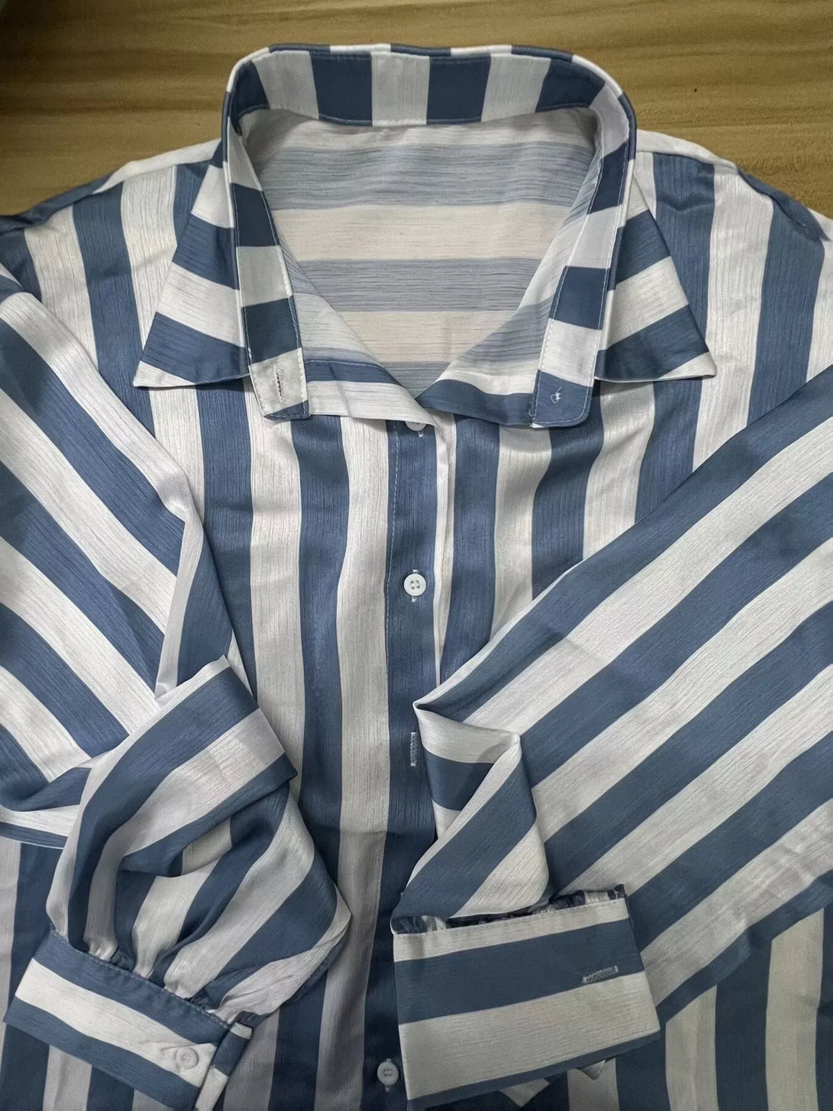 Women’s loose fit striped shirt by Trendsi, featuring a casual relaxed fit with vertical stripes in various colors.